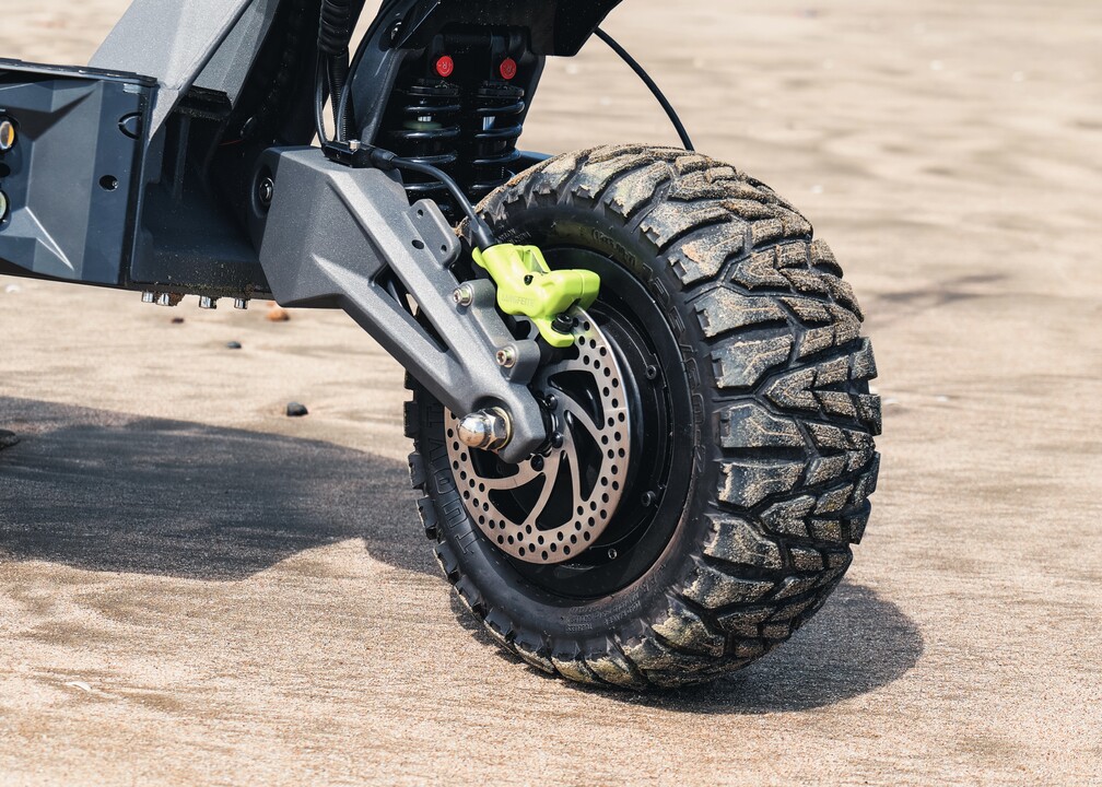 Close-up of a LANGFEITE off-road scooter tire and brake